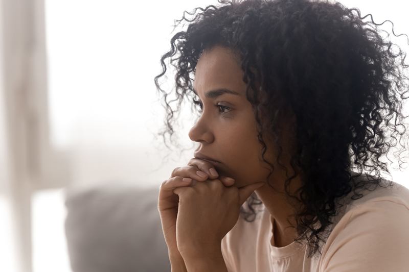 african american woman looking off to the side in contemplation